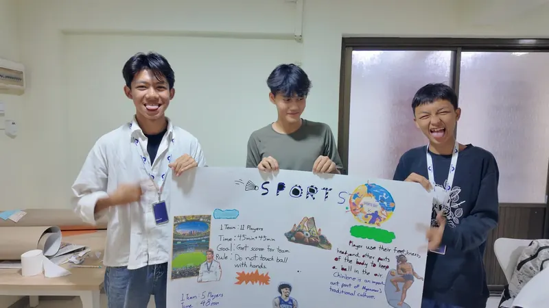 A student presenting to the class in front of a screen